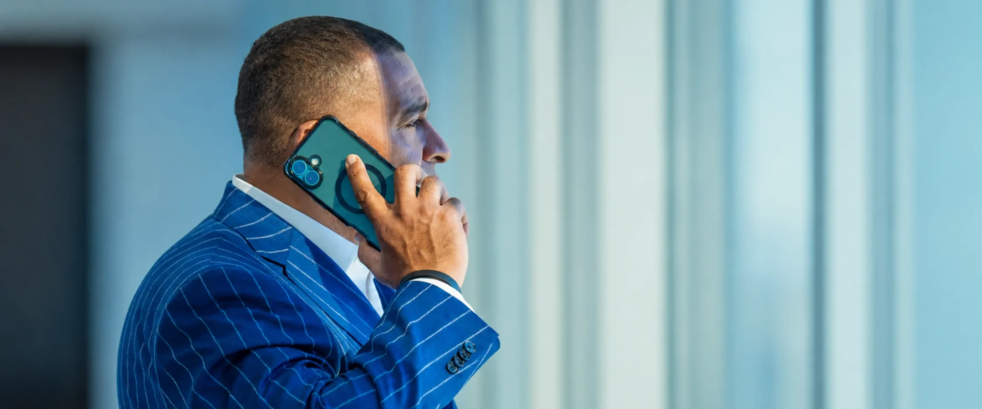 Attorney in a blue pinstripe suit on a phone call